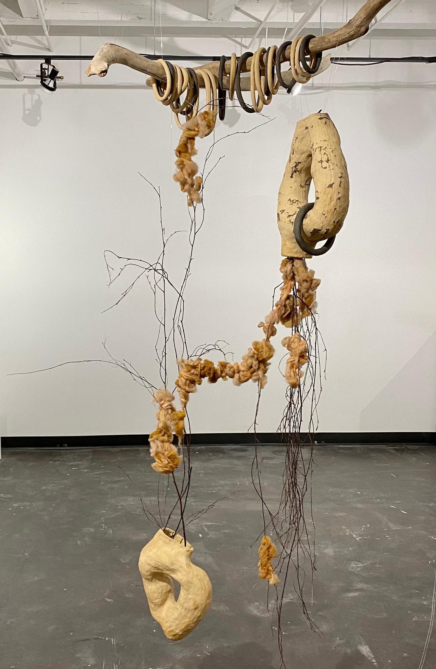 ceramic hanging art installation using ceramic and found wood gallery show